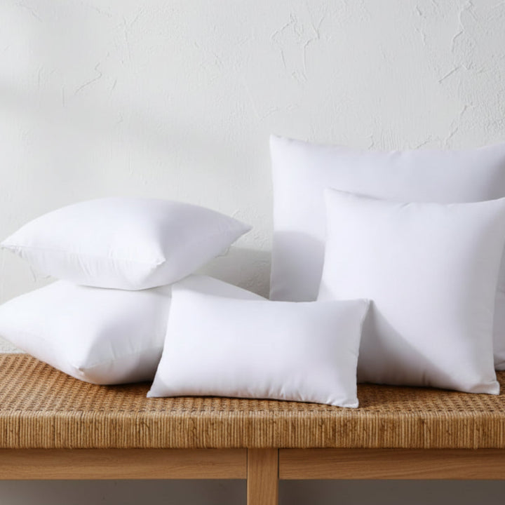 White pillows on a gray surface with a gray background